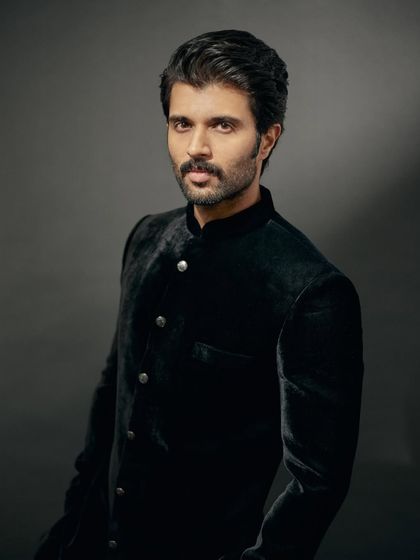 A close-up portrait of Vijay. The velvet bandhgala provides a rich texture that exudes luxury.