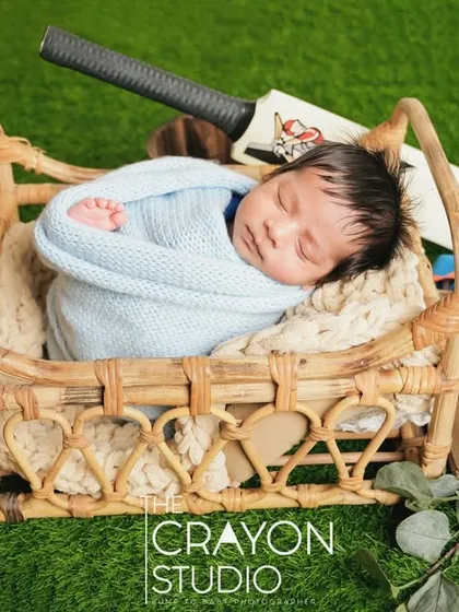 Swaddled and sleeping soundly in a basket, this little cricketer is resting up for the big game.