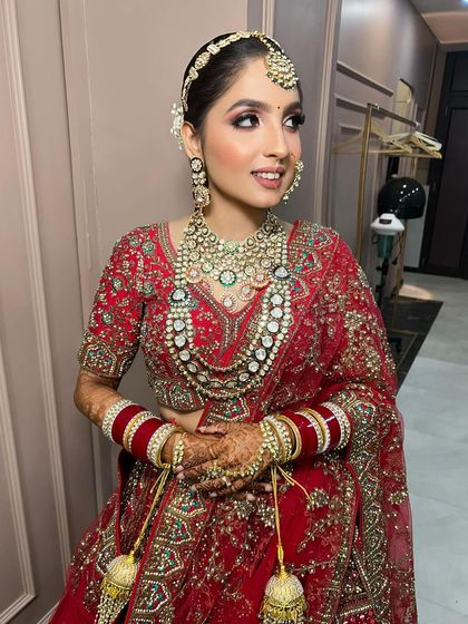 A side profile of the bride, showing her elegant hairstyle and the beautiful details of her jewellery.
