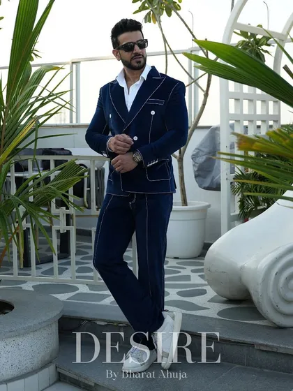 The blue velvet suit in a relaxed, full-length pose. This ensemble proves that luxury can be both comfortable and incredibly stylish.