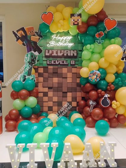 A creative Minecraft themed birthday party with a pixelated block backdrop and game-inspired props.