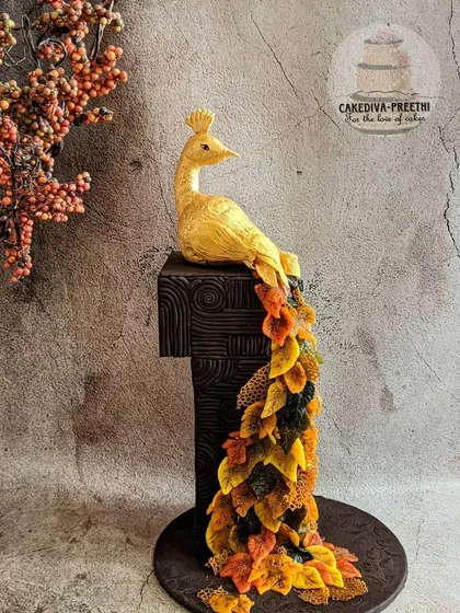 This 24-inch tall autumn-themed peacock is one of my award-winning creations. I shaped the feathers to look like fall leaves using delicate sugar sheets, creating a unique and artistic display. It’s a testament to how we can blend art with baking.