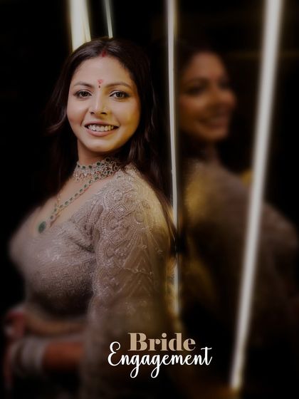 A portrait of the bride on her engagement day, with her reflection visible in the background, creating a sense of depth and elegance.