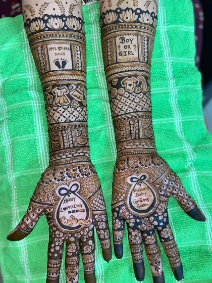 A fun and creative take on baby shower mehandi. This design includes playful elements like 'Baby Loading', 'Boy or Girl?', and tiny baby clothes, making it a memorable part of the celebration.