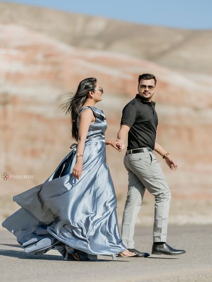 A candid walking shot in the unique, colorful hills outside Baku, Azerbaijan. The wind catching her dress adds a sense of movement and freedom to this destination pre-wedding photo.