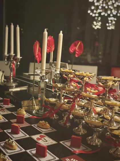 A romantic and dramatic grazing table set up like a chessboard. This "hopeless romantic" table featured textures of cheese and reimagined classic bites, perfect for a wedding event.