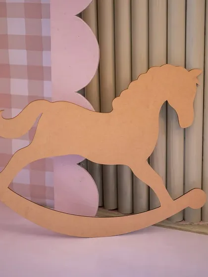 A simple, elegant wooden rocking horse prop that added a touch of classic charm to the baby shower decor.