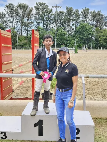 A young rider on the podium after his win. We celebrate the debutantes and the seasoned winners with equal pride, as every achievement is a step forward.