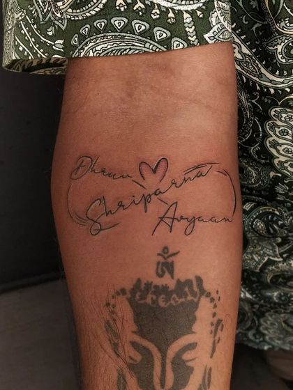 This shot shows the infinity family name tattoo on the arm, placed above another spiritual piece. We can always find the right spot for your new ink.