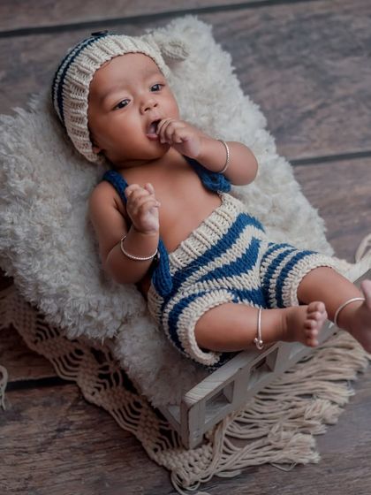 A little sailor boy. This cute, knitted outfit and simple bed prop create a charming and timeless portrait.