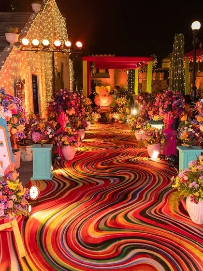 Your pre-wedding functions deserve their own unique identity. For this Mehendi, I created a vibrant, floral wonderland with a psychedelic walkway and lush arrangements, ensuring the energy was bright and joyful from the very first step.