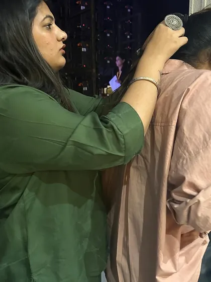 The real magic happens backstage. Here, my team and I are making last-minute adjustments before a model hits the runway at Seeya Fashion Week.