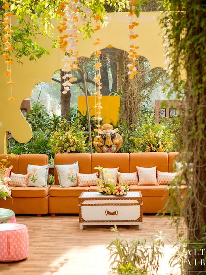 A lounge area at the 'Kesar Sehar' Haldi, with a playful paper-mache tiger head adding a touch of whimsy. The design was about celebrating Indian art and culture in a fun, modern way.