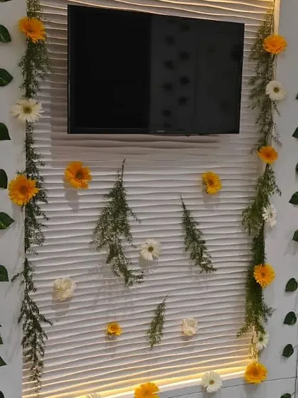 We decorated this feature wall in an office, framing the television with delicate floral and leaf garlands. This is an effective way to make a standard office feature part of the event's decor.