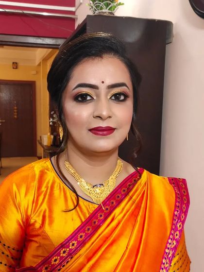 The complete look, showing how the makeup and hairstyle come together with the traditional saree.