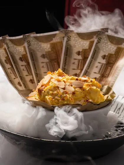 Our Daulat ki Chaat is an ethereal cloud of milk, saffron, and nuts, presented with a touch of theatre. This iconic dessert captures the magic we strive for in every dish, a fleeting moment of pure delight.