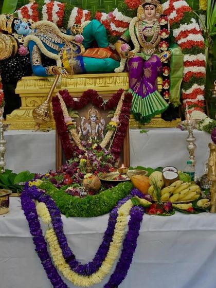 A closer view of the offerings and the beautifully draped deity. Each element is arranged with love and reverence for the festival.