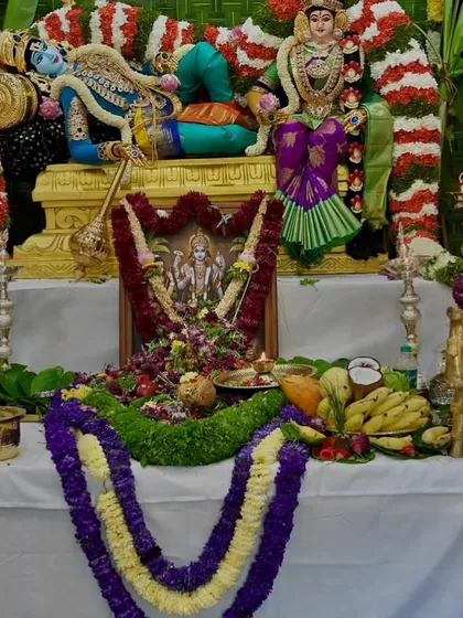 A closer view of the offerings and the beautifully draped deity. Each element is arranged with love and reverence for the festival.