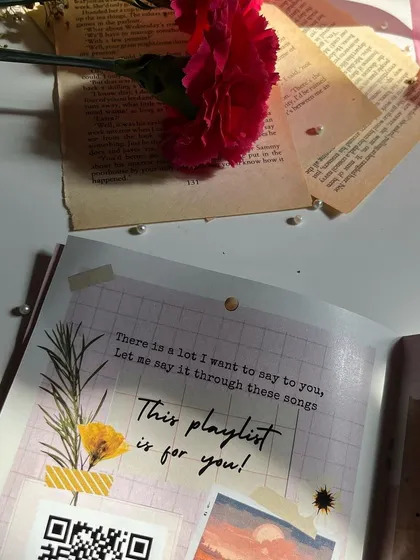 The curated playlist page in the Mother's Day mini journal, complete with a QR code.