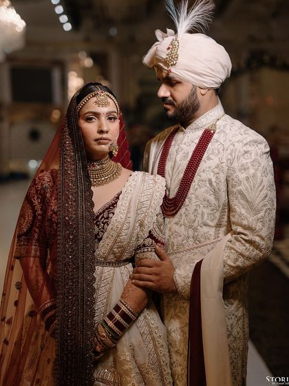 A regal and serious portrait of the couple, Niesha and Sakib, looking powerful and elegant in their wedding attire.