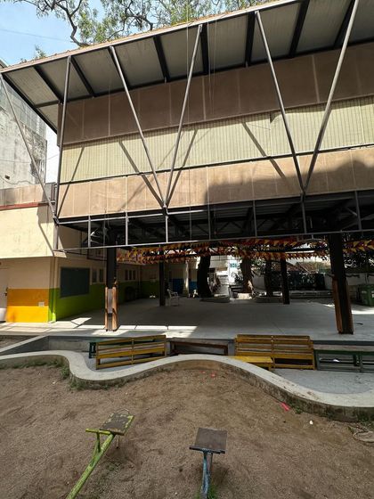 The view of the classroom extension from the sandpit, showing the relationship between the play area and the sheltered space below the classroom.