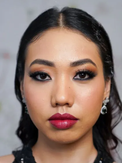 A direct, full-face view of a finished glam makeup application. The lashes are dense and long, creating a captivating frame for the eyes that is both elegant and striking.