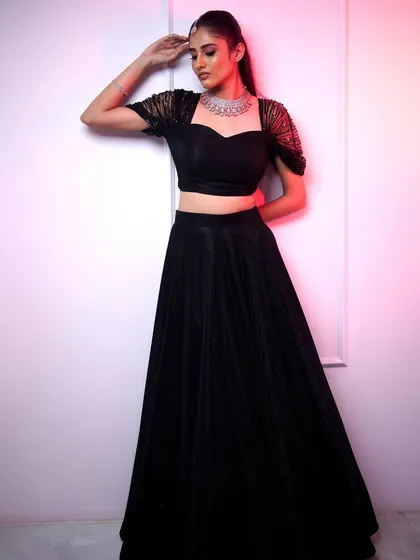 For a modern and chic wedding guest look, we offer elegant American Diamond chokers. This piece pairs perfectly with contemporary outfits like this black lehenga, making it ideal for receptions or cocktail parties.