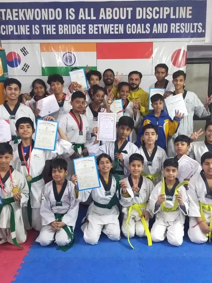 The entire academy celebrates after a successful belt promotion and medal ceremony. It's a day of joy and achievement for everyone.