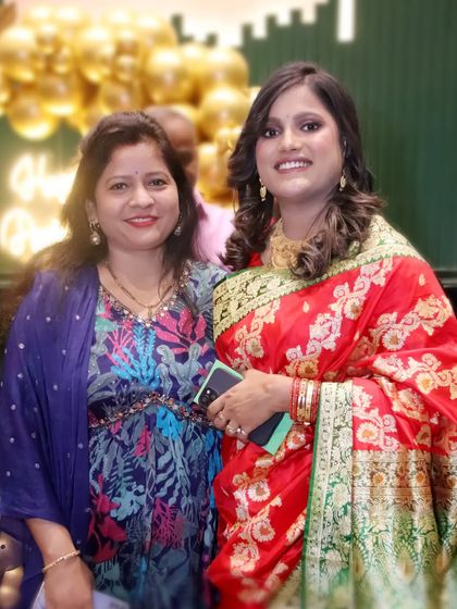Two women in beautiful traditional sarees at a celebration. I capture the vibrant colors and elegance of ethnic wear.