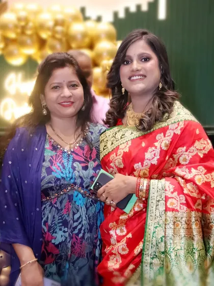 Two women in beautiful traditional sarees at a celebration. I capture the vibrant colors and elegance of ethnic wear.