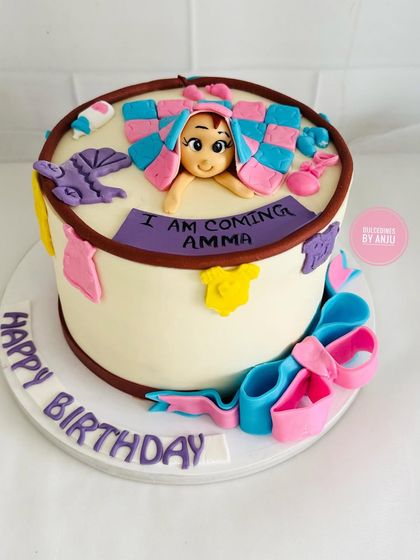 These cakes are too cute to handle! A fun "I am coming Amma" baby shower cake.
