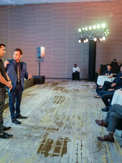 Interacting with a volunteer on stage at the Panasonic event. These unscripted moments of connection and surprise are often the most memorable part of the show.