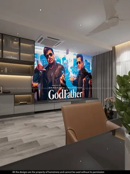 A living room can become a cinematic paradise. Here, a high-definition projector screen descends from the ceiling, complemented by a bespoke entertainment unit that keeps the space elegant and functional for everyday life.