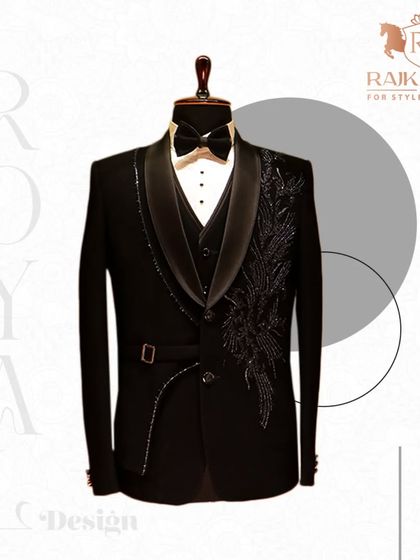 A royal design for a special occasion. This black tuxedo features an embellished lapel and a side buckle detail, creating a look that is both classic and contemporary.