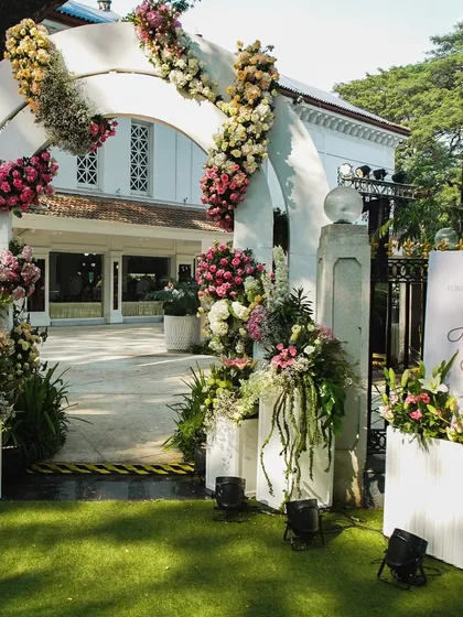 The grand entrance to a wedding, with a floral archway that welcomes guests into a world of romance and celebration.