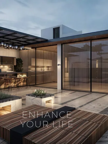 This terrace design seamlessly connects an indoor kitchen and bar with an outdoor lounge area. Featuring large glass sliding doors, marble planters, and custom wood seating, it's a versatile space designed for entertaining and enjoying the evening sky.