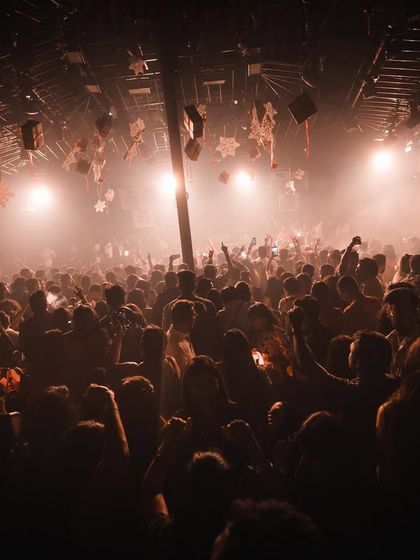 An atmospheric shot of the dense crowd at Hammerzz, lost in the music under warm lights.
