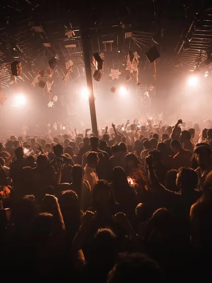 An atmospheric shot of the dense crowd at Hammerzz, lost in the music under warm lights.