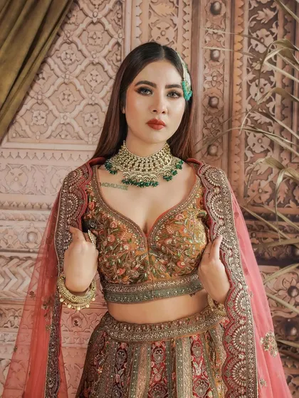 The rich, embroidered lehenga is the star, and the makeup is designed to match its opulence. This is for the bride who wants to make a statement.