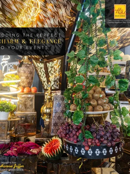 We add charm and elegance with our elaborate fruit and decor displays. This setup features carved watermelons, fresh grapes, and intricate lanterns, creating a visually stunning corner.