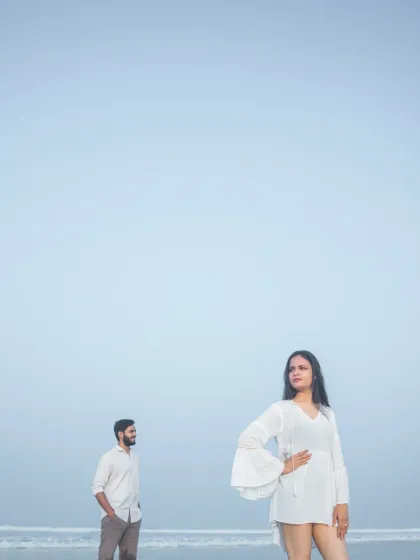 A modern and artistic pre-wedding portrait on the beach, using negative space to create a visually striking and contemporary image.