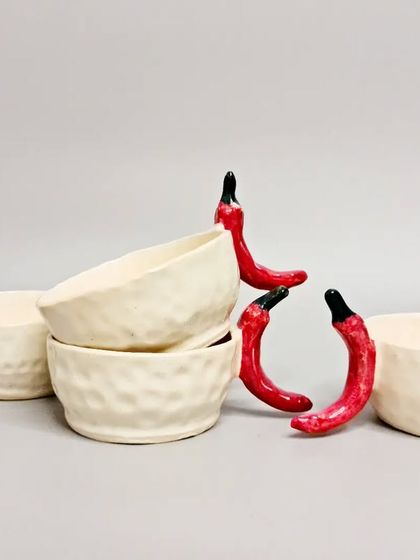 Part of my quirky everyday collection, these mugs feature bright red chili handles. They are designed to add a dash of whimsy and turn an ordinary item into something extraordinary.