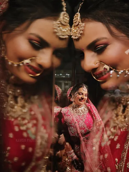 A creative wedding portrait using reflections to create a kaleidoscope effect of the smiling bride.