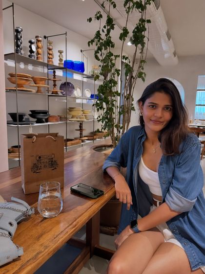 A classic casual Sunday look. A white tank top and shorts paired with an open denim shirt is a go-to combination for a relaxed yet put-together weekend vibe.