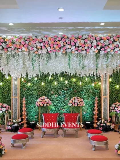 This Vidhi Mandap is a sanctuary where tradition meets artistry. We combined a lush green wall with cascading white florals and rich red seating to create a sacred space that feels both grand and intimate.