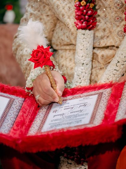 A close-up of the groom signing the Nikah Nama, the official marriage contract. Capturing these significant details is essential to telling the full wedding story.