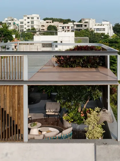 A multi-level rooftop landscape where planters with native species define movement and frame views. The greenery is not just decoration but a central idea of the structure, integrating the building with its environment.