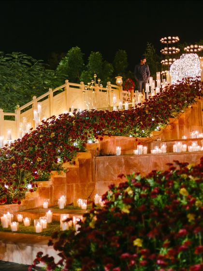 The grand staircase at Suryagarh was decorated with cascading red chrysanthemums and hundreds of candles. This transformed a simple architectural feature into a stunning, romantic backdrop for the evening's festivities.