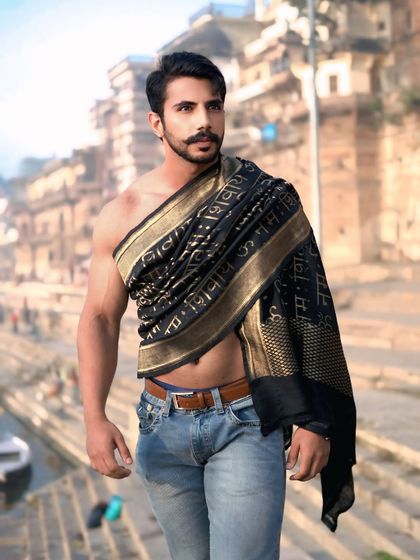 A confident and stylish portrait that perfectly balances modern fitness with the spiritual aesthetic of Banaras.