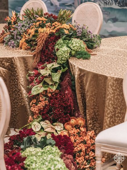 A cascading floral runner at the 'Orchard of Life' naming ceremony, a symbol of abundance.